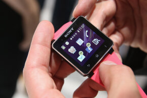 2013年德国柏林国际消费电子展上，参观者在索尼展台上试用SW2智能手表。“border=
