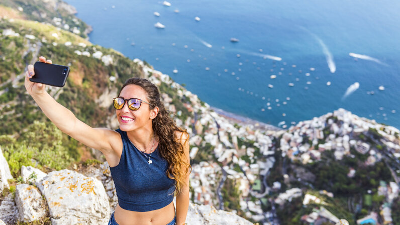 woman taking selfie on cliff